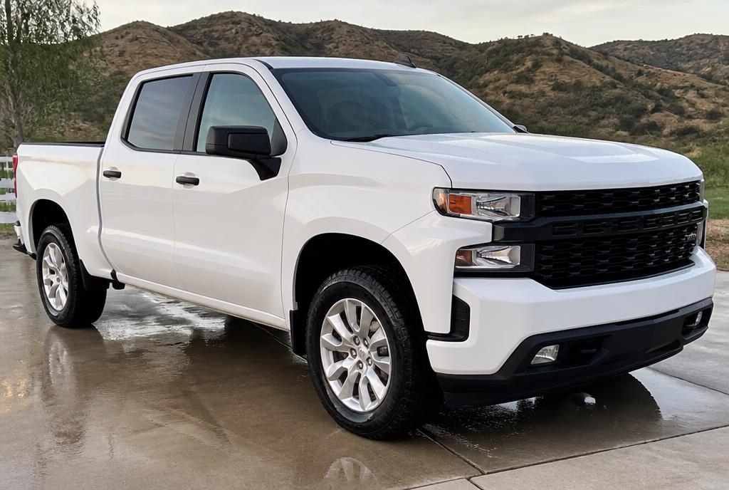 Clean white crew cab pickup truck after a wash and detail